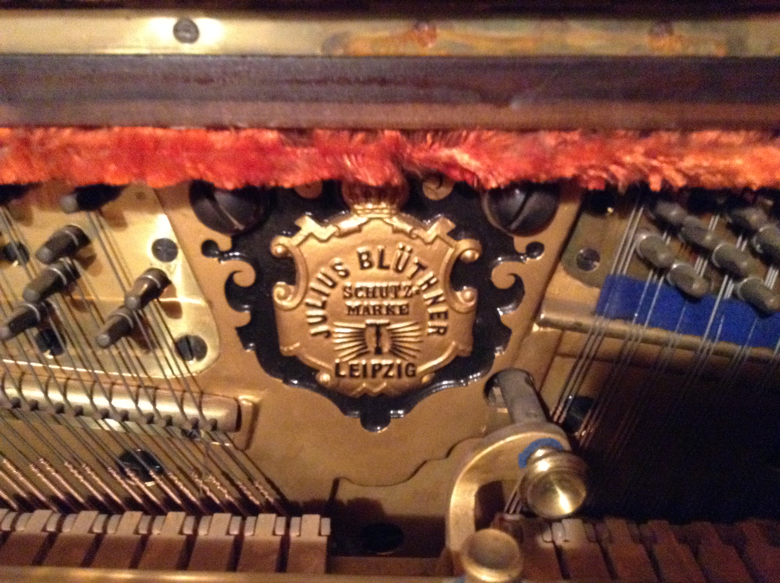 Bluthner piano logo inside upright soundboard